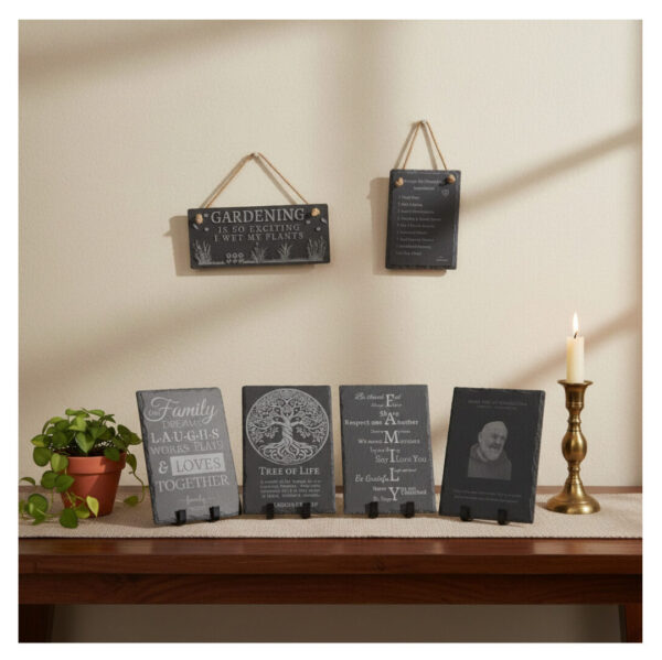Natural slate engraved plaques for Home Decor, each resting on stands on a tabletop with two various size engraved slates hanging by rope behind